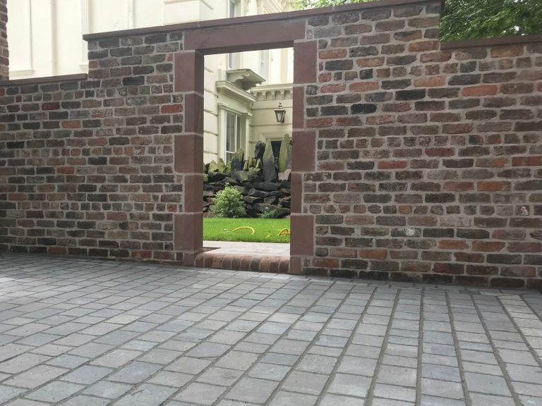 Handmade brick garden retaining wall with sandstone copings and steps built in South Liverpool