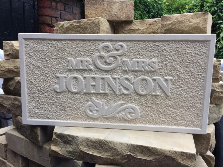 Relief carved sandstone sign