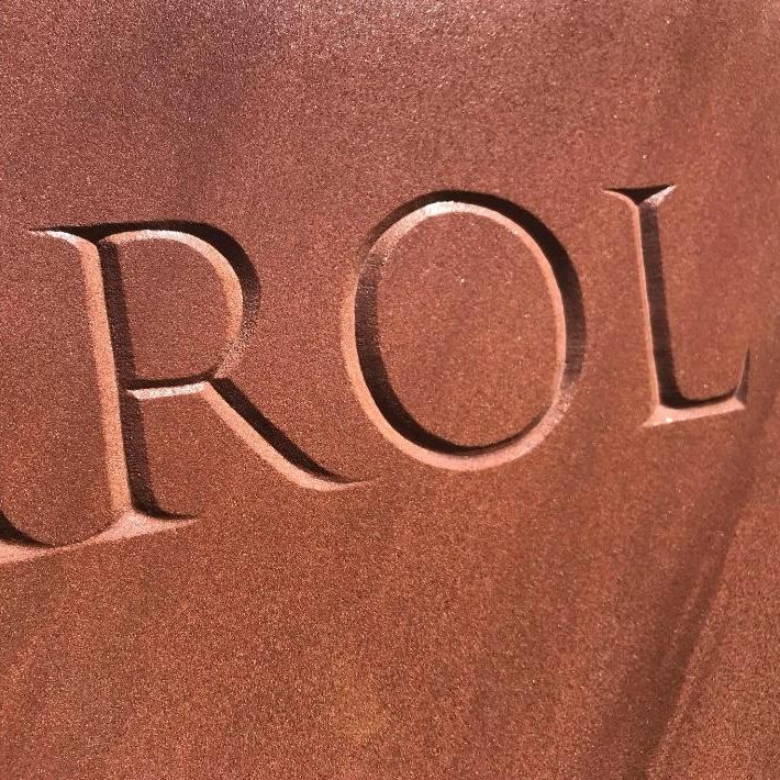 V-cut lettering on a sandstone plaque