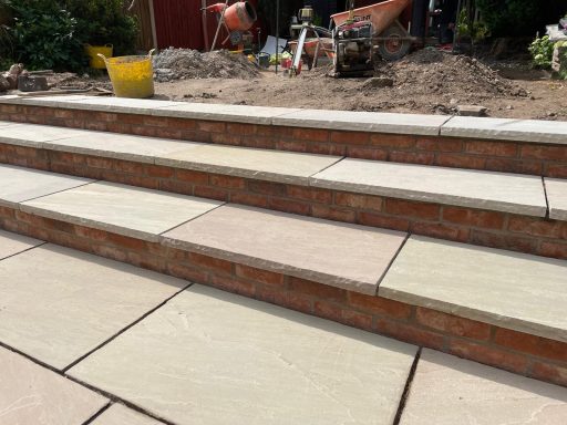 Natural stone patio in South Liverpool with sandstone steps and handmade brick risers